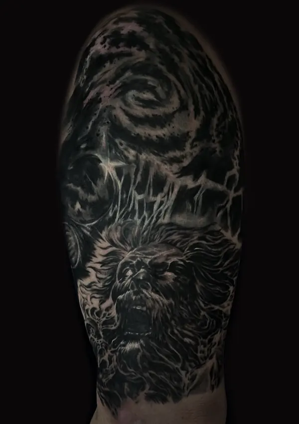 Dark black and grey cover-up tattoo on the upper arm by Gwen, Pattaya