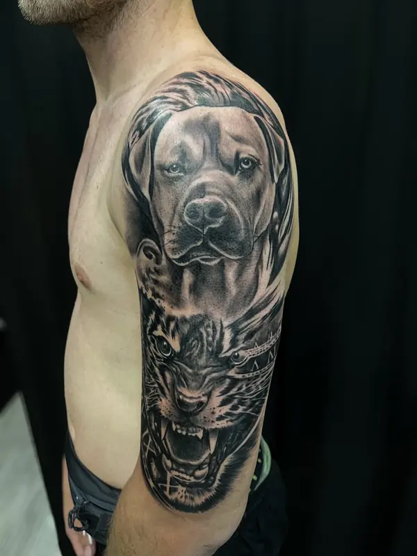 Realism tattoo by Gwen — dog and tiger portrait sleeve, black and grey